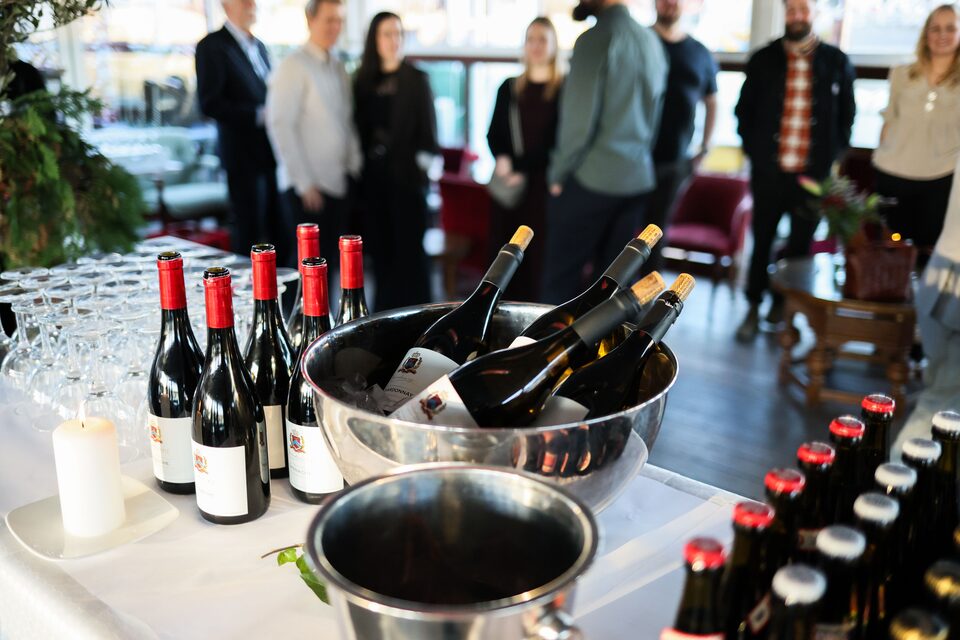 Guests mingling with drinks at an evening corporate reception.